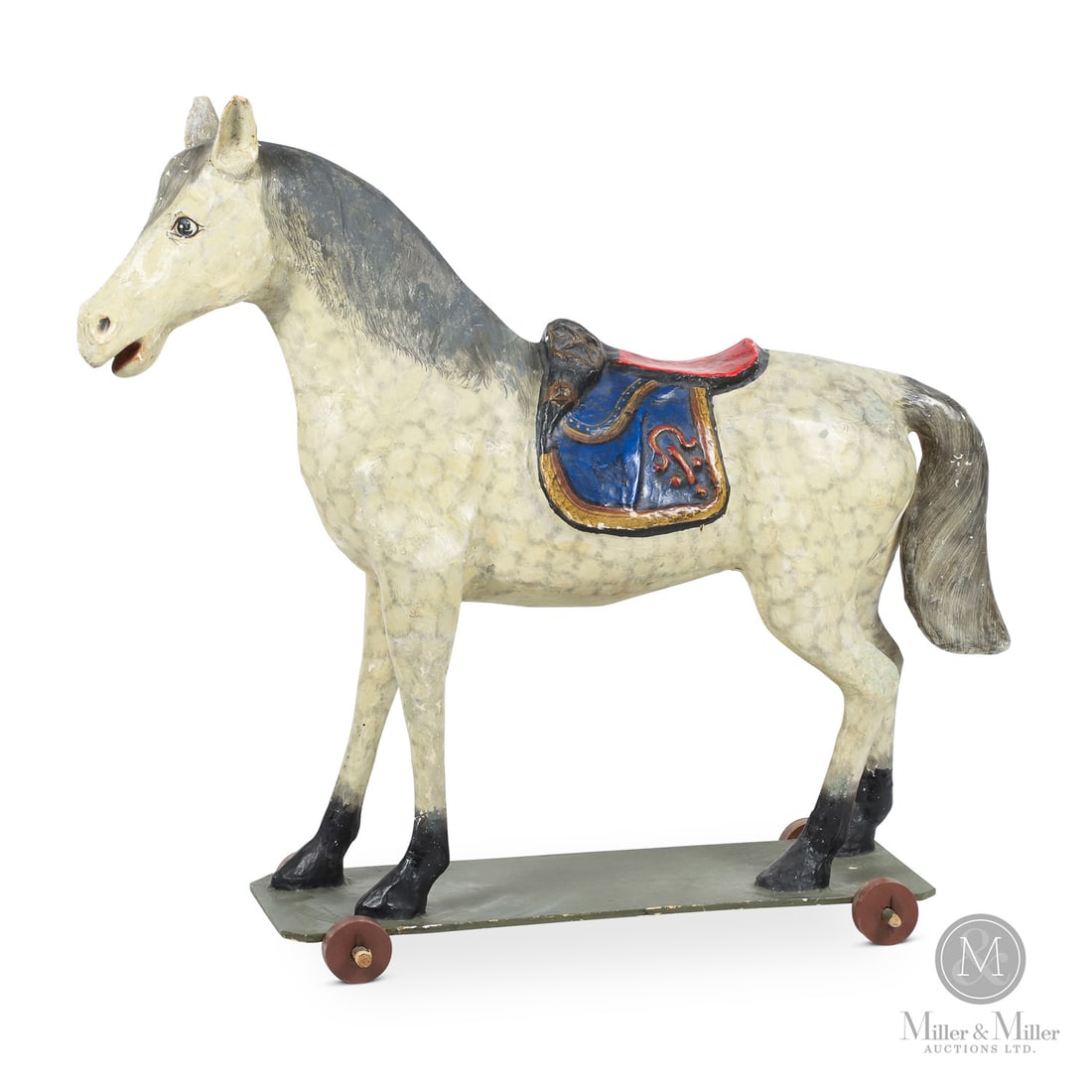 Monumental Toy Horse: Likely German. Wood, papier mache. A large toy horse on a wheeled wooden platform purportedly used in an Eaton's Christmas window display. In original paint, the horse is a composition/papier mache, i