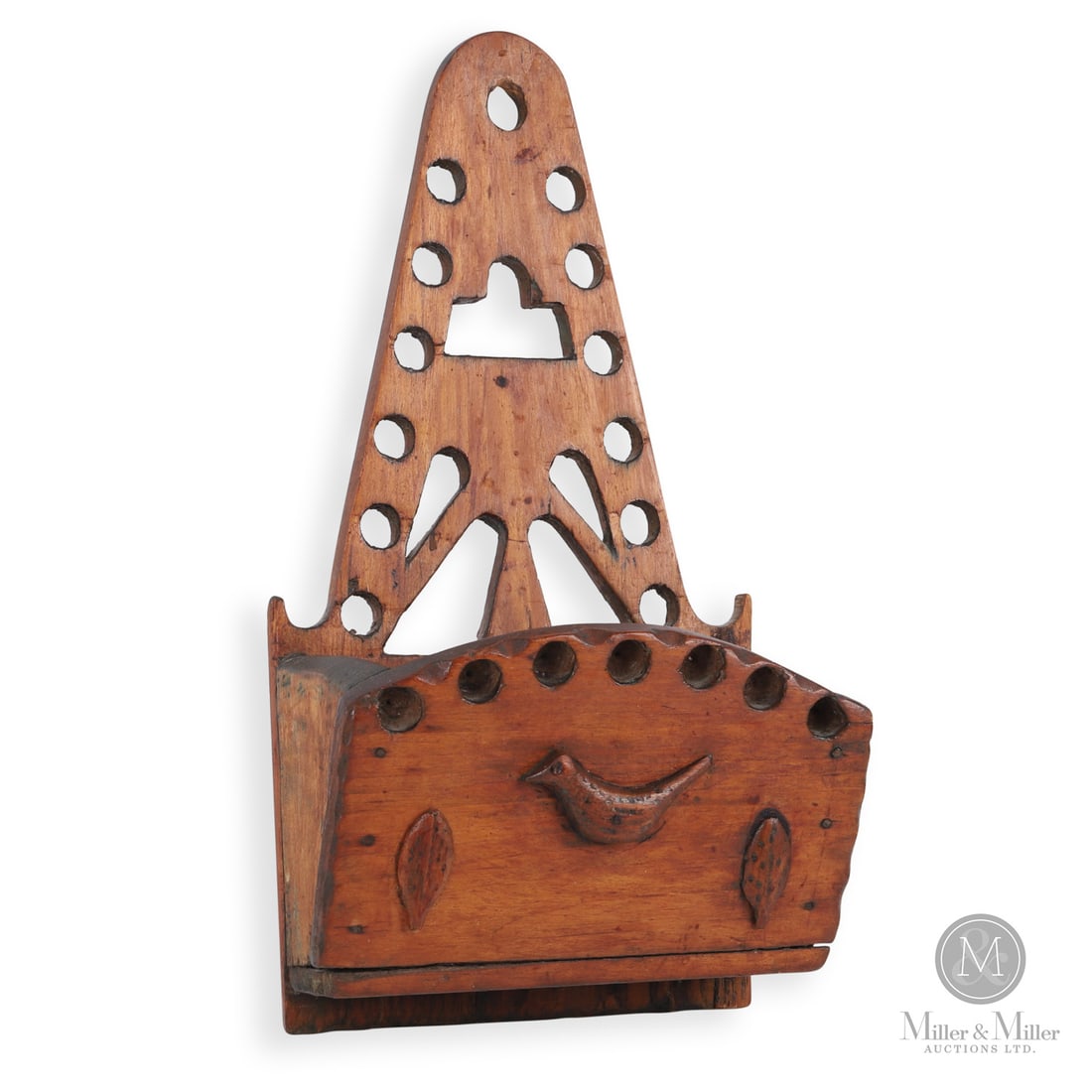 Waterloo County Wall Box: Canadian. Wood. A pine wall box from Waterloo County with a pierced tapered backboard and the front panel having a carved applied bird at the centre flanked by two applied leaves. The front panel is a