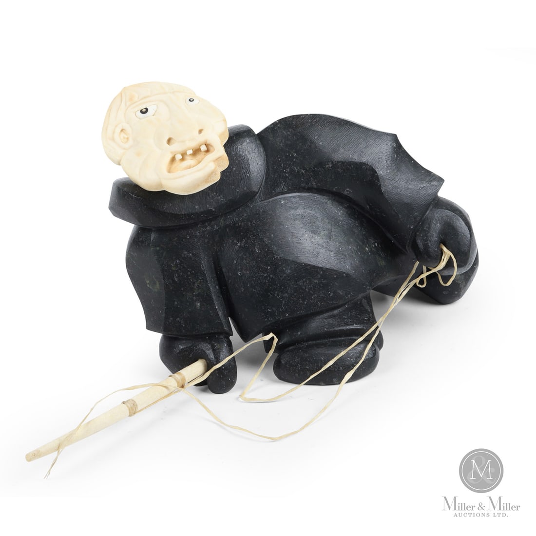 Inuit Hunter by Michael Massie: Canadian. Soapstone. A soapstone sculpture of an Inuit hunter with a spear by Michael Massie, Labrador. Carved in soapstone with the head and face carved in bone as a separate piece and mounted on a