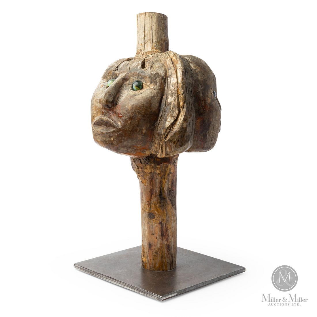 Burl Multi-Face Sculpture: Canadian. Wood. A three-face sculpture possibly representing a family unit of mother, father, and child, innovatively carved from a natural burl branch and mounted on a contemporary steel base. Each f