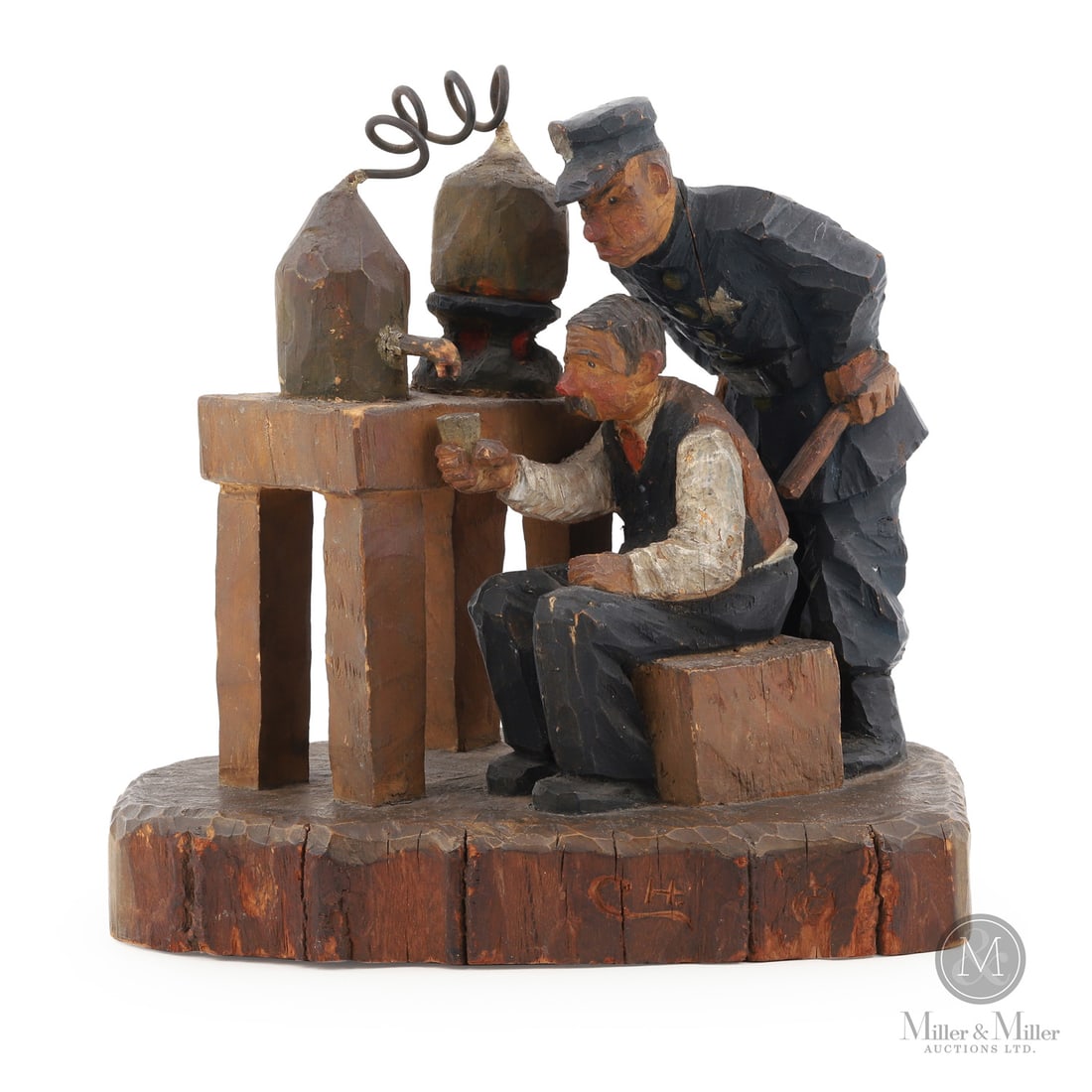 Folk Art Carving Prohibition scene: Canadian. Wood. A folk art sculpture of a prohibition scene carved and painted in the manner of the Trygg family. The scene shows a man at his still, testing quality, while a policeman looks over his