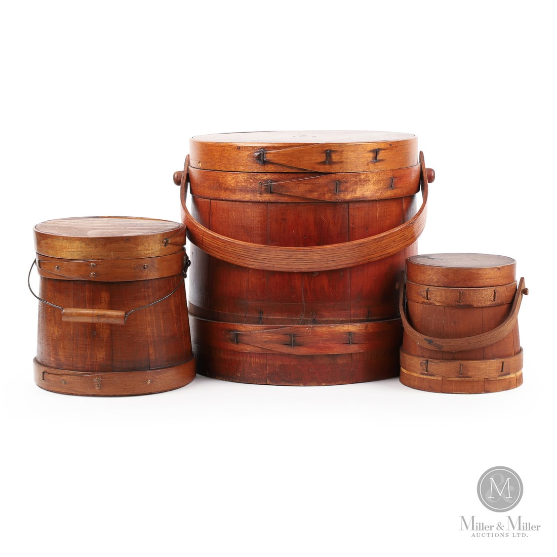 Trio of Firkins: Canadian. Wood. A lot of three refinished firkins, the smallest and largest having original wood handles and the other with its original wire/wood handle. Very good condition, the band on the lid of