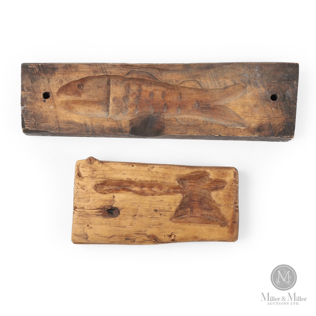 Two Maple Sugar Molds: Canadian. Wood. Lot of two maple sugar molds, the first being a single fish mold carved in maple and with good detail, early 20th century, and the second being a pine carved mold with a broad axe moti