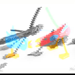 Pair of Barry Colpitts Singing Birds: Two brightly painted birds seem to be confronting (or singing) to one another. Neither is backing down.