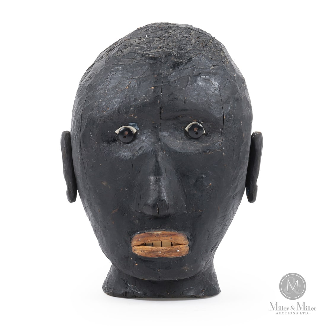 Alcide St. Germain Head Carving: A carved, painted head by prolific yard artist Alcide St. Germain (1911-1978). St. Germain's carvings ranges from animals to life-sized humans. He filled his front porch and yard with carvings like
