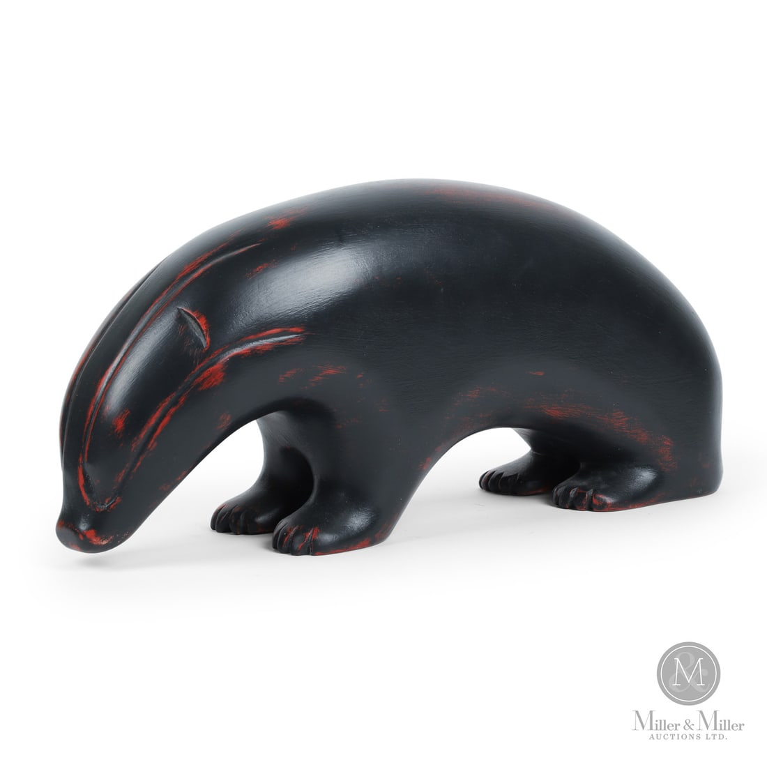 Robert Wylie Badger: Typically carved in basswood, Wylie's (1932-) works are highly finished with polished monochromatic surfaces featuring animals, angels, crosses. Here a stylized bear is well-carved, ebonized with