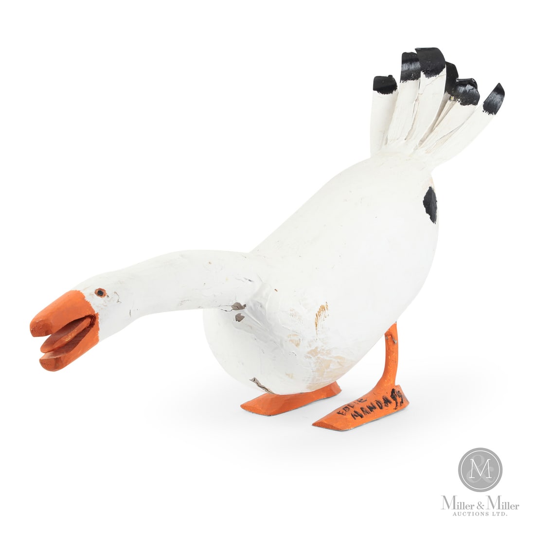 Eddie Mandaggio Goose: Here is a classic example of the work of Eddie Mandaggio (1927-2020) , a quacking or hissing duck. Well-painted and a generous size, Mandaggio shows a naive yet strong hand in this carving.