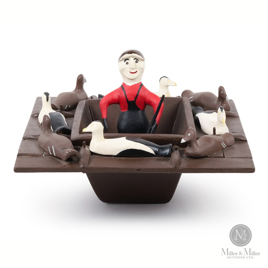 Charlie Tanner Duck Blind: This is a rare representation of a hunter in a duck blind by Charlie Tanner (1904-1982). Nicely carved and painted, the happy looking hunter in his hip waders stands ready in the boat with decoys