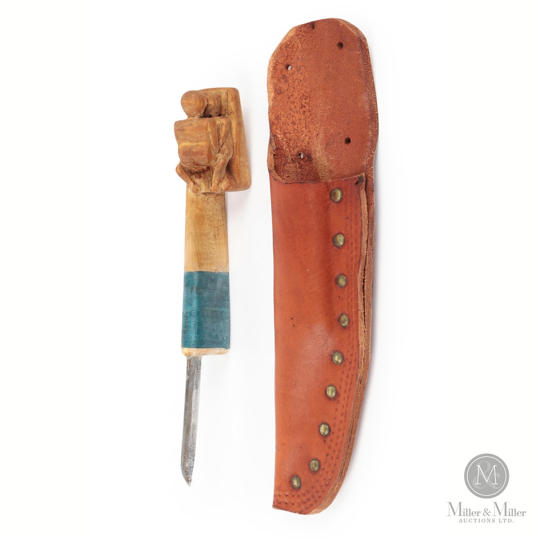 Clarence "Bubby" Mooers Naughty Crooked Knife: Crooked knife makers often decorated the handles of their pieces with carved decorations such as animal heads or symbols like hearts or initials. In this case, carver Clarence "Bubby" Moores