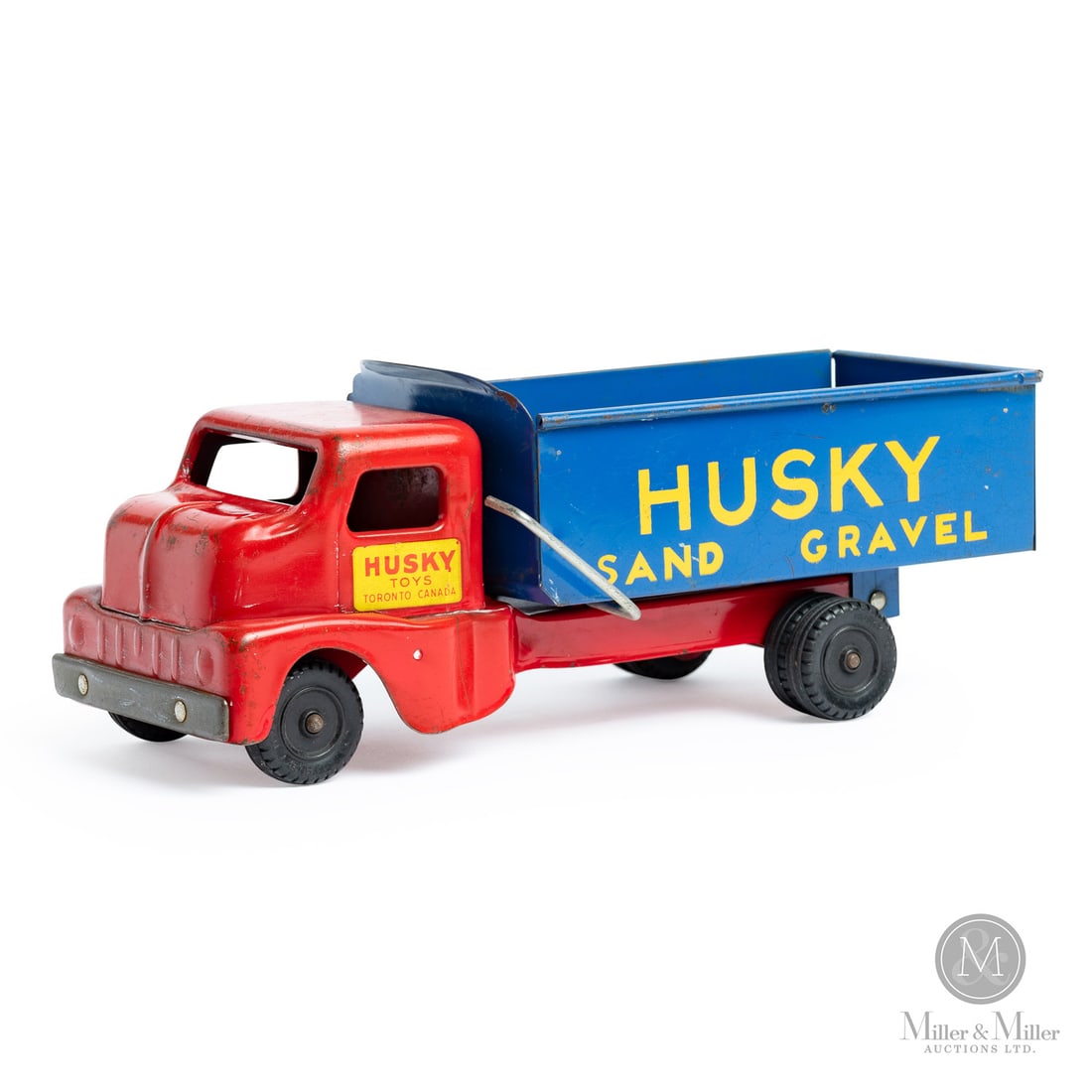 Husky "Sand and Gravel" Truck: Canadian. 1960s. Pressed steel. Marked, "Husky Toys Toronto Canada", on cab doors and tires. From the Yvan Lalonde Collection.Size4.5" x 4.5" x 12".ConditionVery good condition. Original paint and
