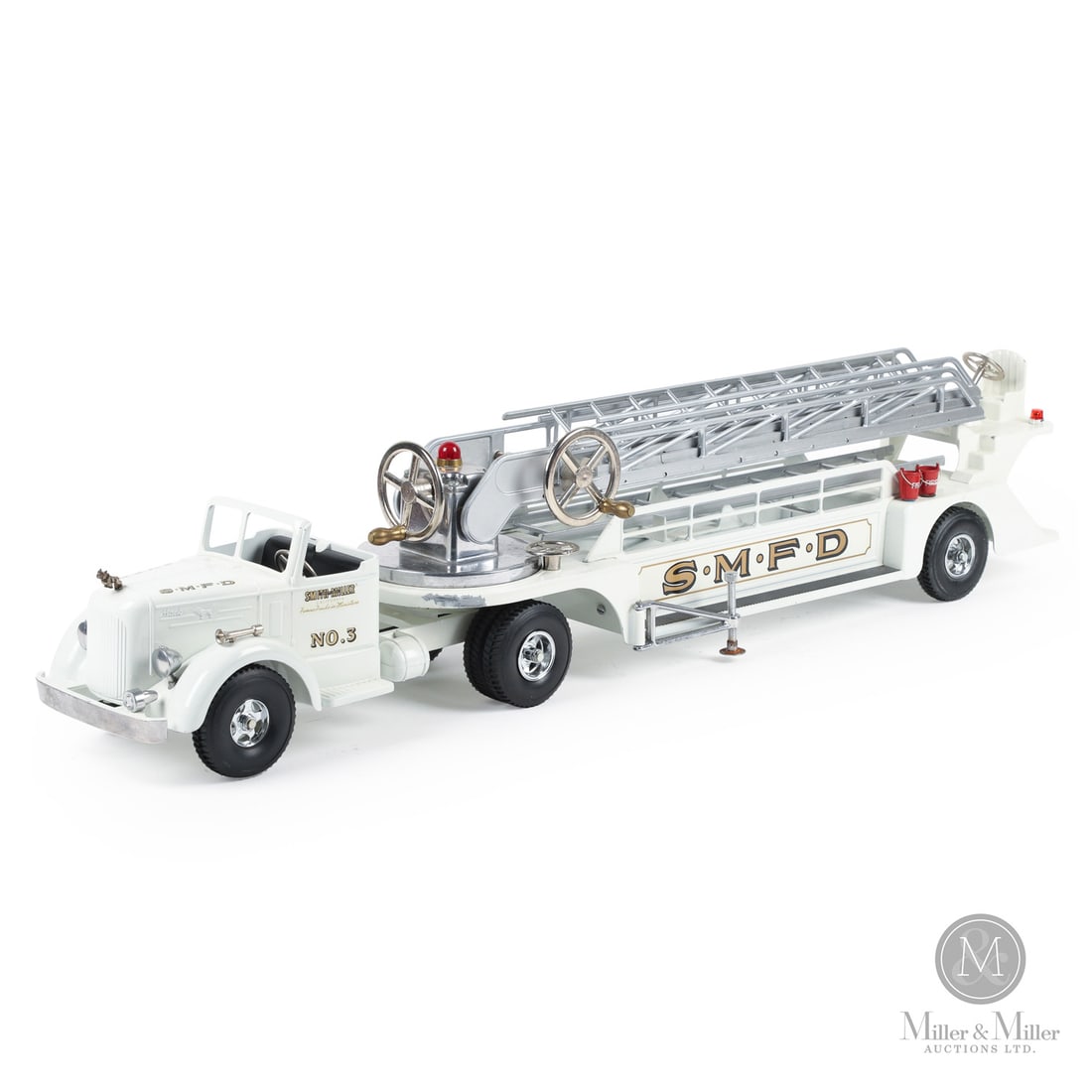Smith-Miller S.M.F.D. No. 3 MACK Fire Truck: American. 1949-1952. Pressed steel, aluminum. This toy has an unusual mark on the chassis, an "H" casting identity mark with some embellishments. When Bob Smith left Smith-Miller, Matt Miller was look