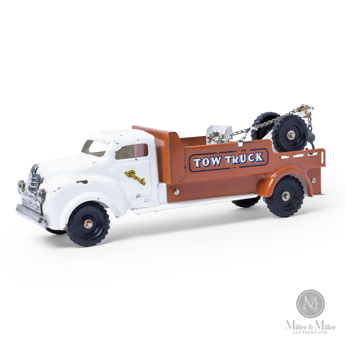 Lincoln Toys Tow Truck: Canadian. 1950s. Pressed steel. There were a number of colour variations for the Lincoln Tow Truck, such as blue, red, yellow, or gray cabs with coloured beds. The brown and white colour scheme, as se
