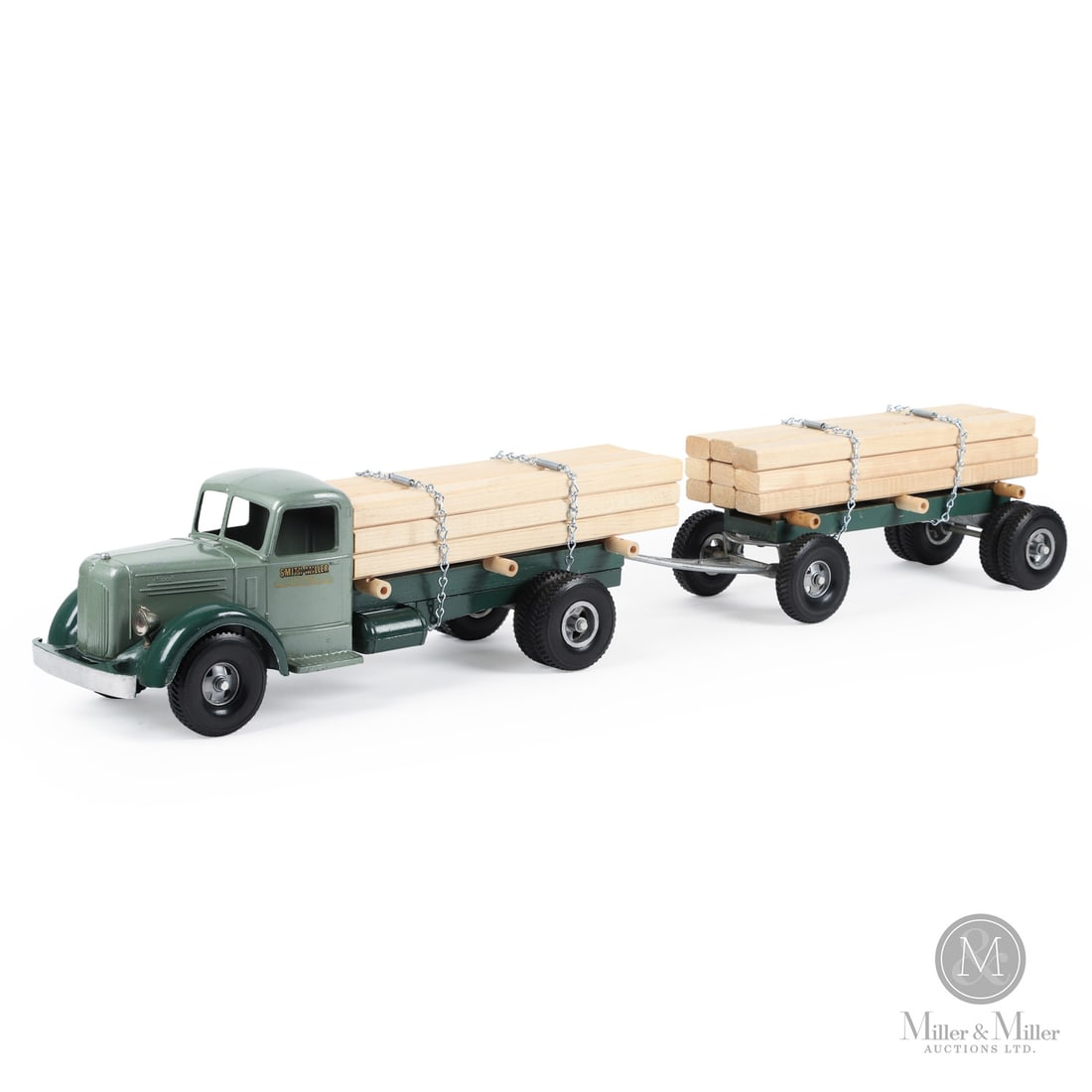 Smith-Miller Lumber Truck With Pup Trailer: American. 1949-1952. Pressed steel. This toy has an unusual mark on the chassis, an "H" casting identity mark with some embellishments. When Bob Smith left Smith-Miller, Matt Miller was looking for a