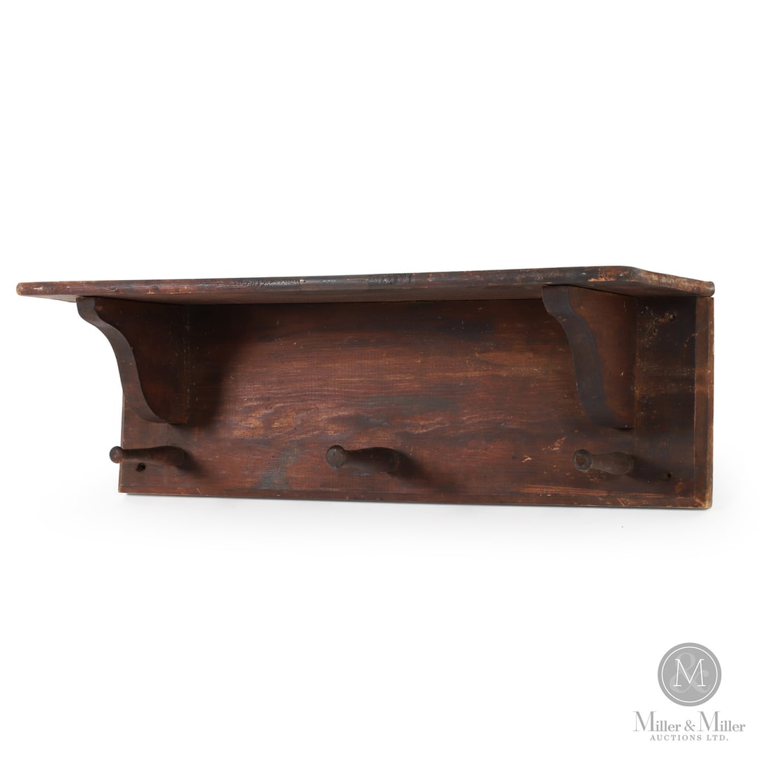 Shelf With Cloak Pegs: Canada. Mid 19th Century. Wood. A large pine shelf with three prominent turned cloak hooks and in original red/brown varnish surface. Unmarked. 12" x 39" x 12". From the Late Miller Carmichael