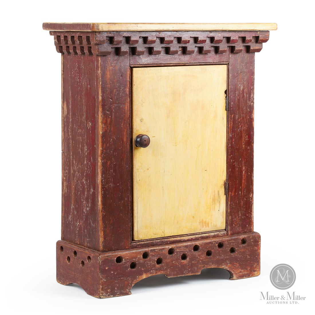 Small One-door Cupboard: Canada. c. 1890. Wood. Small one-door cupboard having a pierced bracket base in two colours and with a pale yellow top and door and a red painted case. Unmarked. 27" x 22.5" x 10.5". From the Late