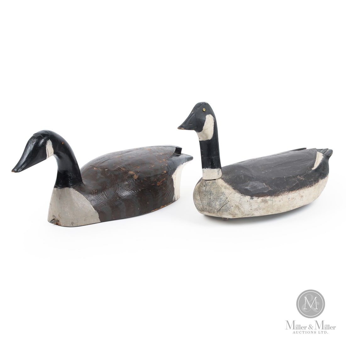 Pair of Canada Goose Decoys: Canada. Third Quarter 20th Century. Wood. A lot of two Canada Goose decoys one with a straight neck, tack eyes and carved wing profile and the other with a curved neck and crossed tail feathers. Both