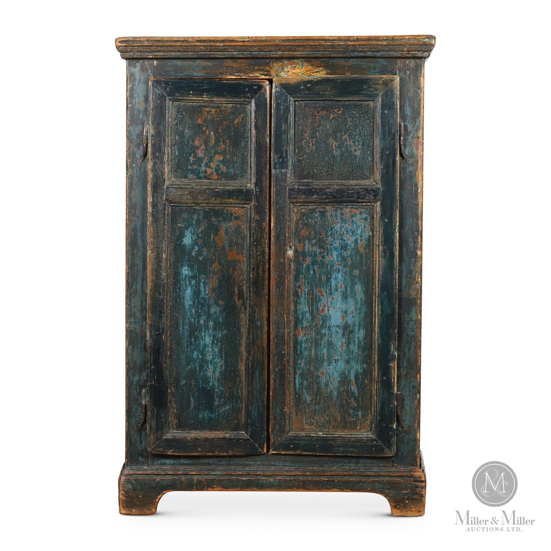 Small Blue Quebec Armoire: Quebec, Canada. Early 19th Century. Wood. A small pine armoire with bracket base, rat-tail hinges, and original blue paint. Naive construction having plank doors with applied face moldings to simulate