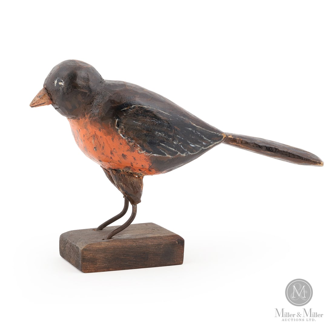 Primitive Carved Robin: Quebec, Canada. Third Quarter 20th Century. Wood. A naive carved Robin in original paint with wire rod legs and mounted on the original base. Marked, "BABY ROBIN?" underneath. 6" x 2.25" x 9.25".