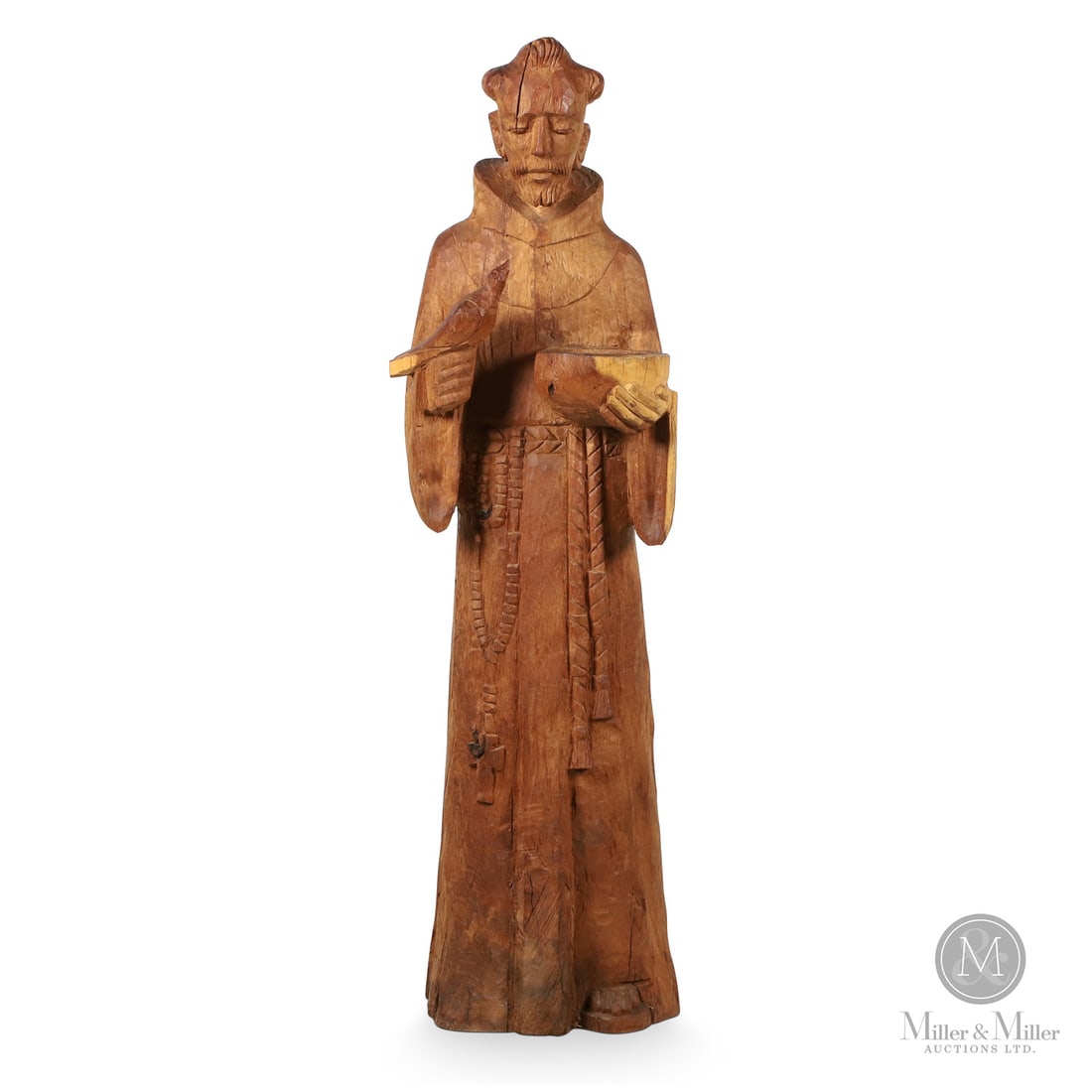 St. Francis Wood Sculpture: Canada. Early 20th Century. Wood. A sculpture of St Francis of Assisi holding a bird in one hand. Origin unknown. Unmarked. 47" x 14" x 12". From the Late Miller Carmichael Collection. Canada. Early