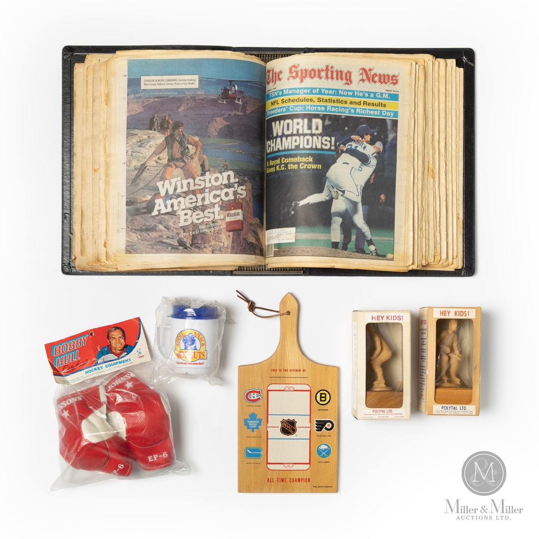 New Old Stock Hockey Grouping: The group of hockey-related material offered here includes a new old stock Eddie Shack Donuts mug, Bobby Hull elbow guards, NHL kitchen cutting board, and a pair of Polytal "Paint your Favorite
