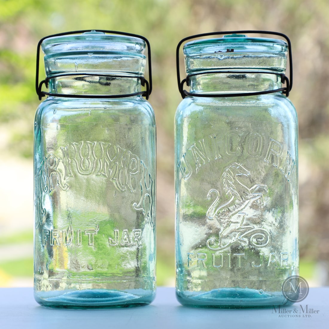 Pair of Australian Jars: Size Unicorn. 9 3/4" x 4 5/8" base diameter. Triumph. 10" x 4 1/2" base diameter. Medium Glass.