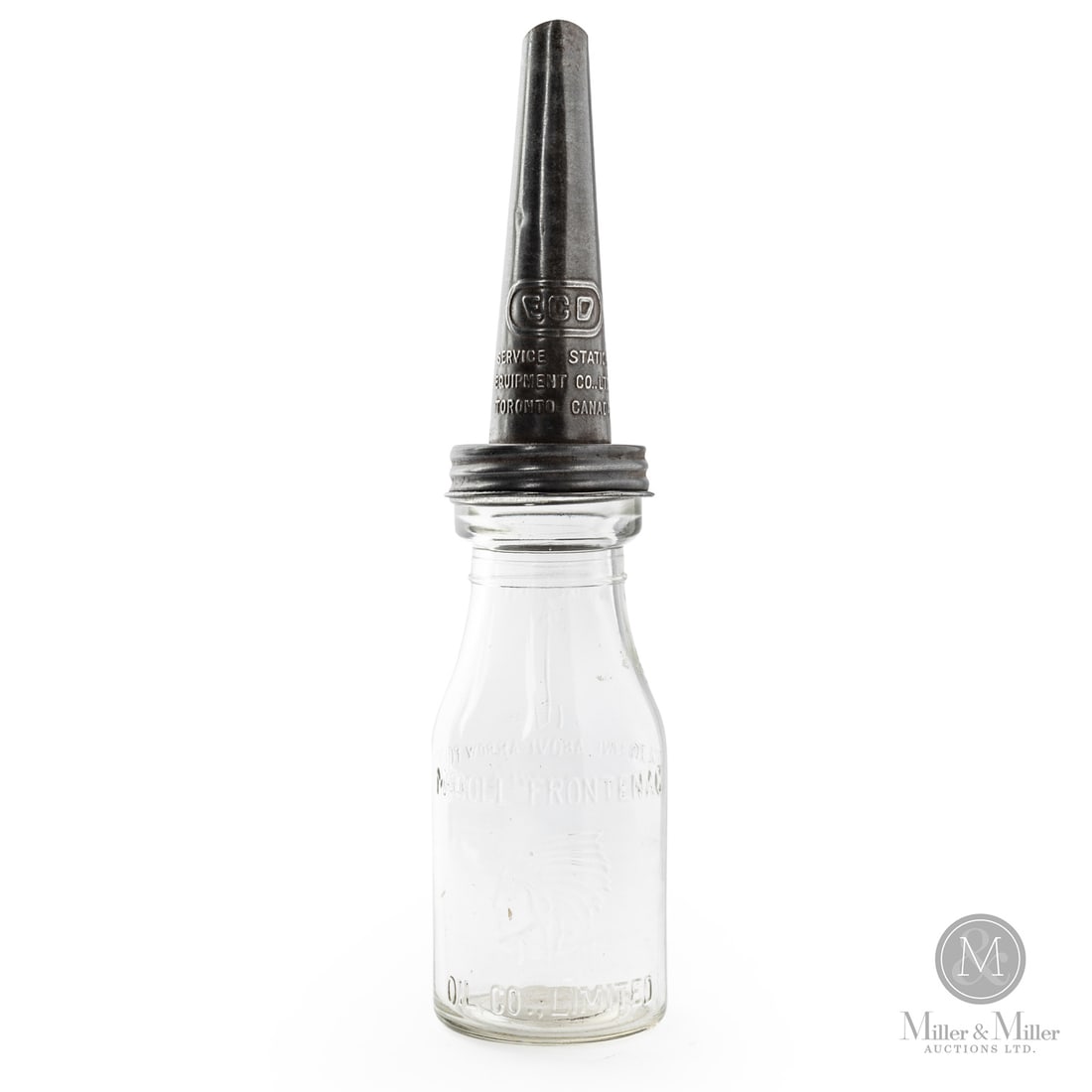 McColl-Frontenac Pint Oil Bottle: 1927 - 1941. Glass bottles with tin spouts. Embossed. Some roughness to base edge and lip. Free of chips. Retains spout. 13.5" x 3" Dia. Size 13.5" x 3" Dia. Condition Some roughness to base edge and