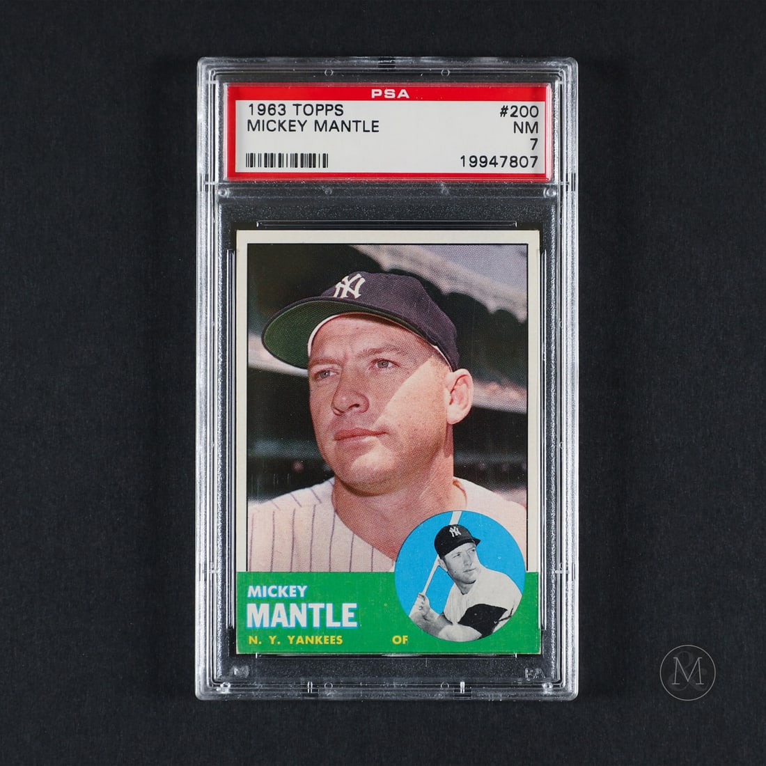 1963 Topps #200 Mickey Mantle (PSA 7 NM): Offered here is the 1963 Topps Mickey Mantle base card (#200). This base issue is highly significant due to its design layout, which frames a prominent close-up portrait beside a small circular action