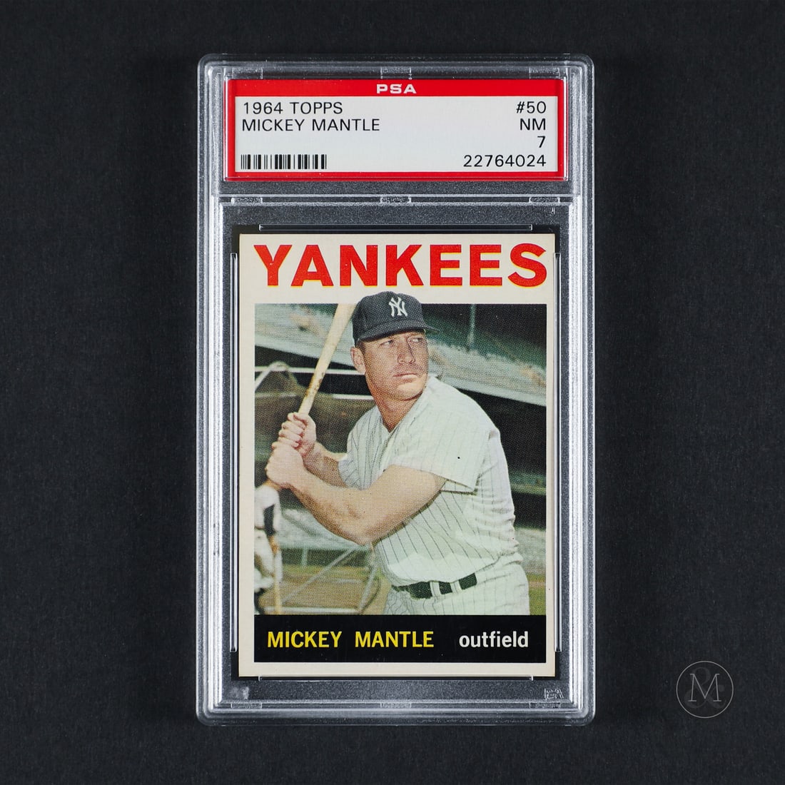 1964 Topps #50 Mickey Mantle (PSA 7 NM): Offered here is the 1964 Topps Mickey Mantle base card (#50). This issue is significant as a base checklist anchor featuring a prominent card-front design with large block lettering over an open