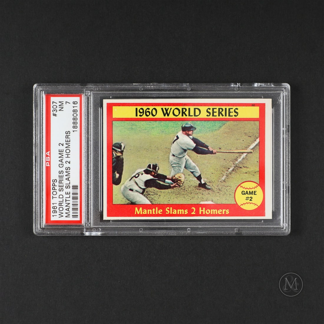 1961 Topps #307 Mantle Slams Two Homers (PSA 7 NM): Offered here is the 1961 Topps #307 Mickey Mantle featuring the Yankee legend during a clutch world series performance. The card shows Mantle slamming a home run during Game #2 of the World Series.