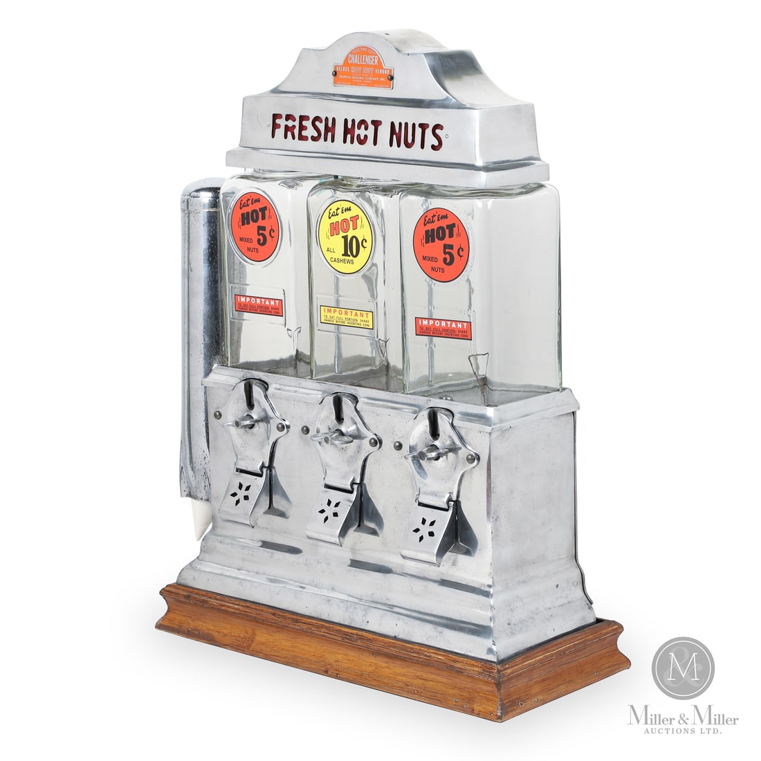 Challenger Hot Nuts Vending Machine: Made in U.S.A. 1926 - 1930s. Polished metal. Chrome plated case and cup dispenser. The heating mechanism is located beneath the glass containers so that only the lower nuts are roasting. This keeps th
