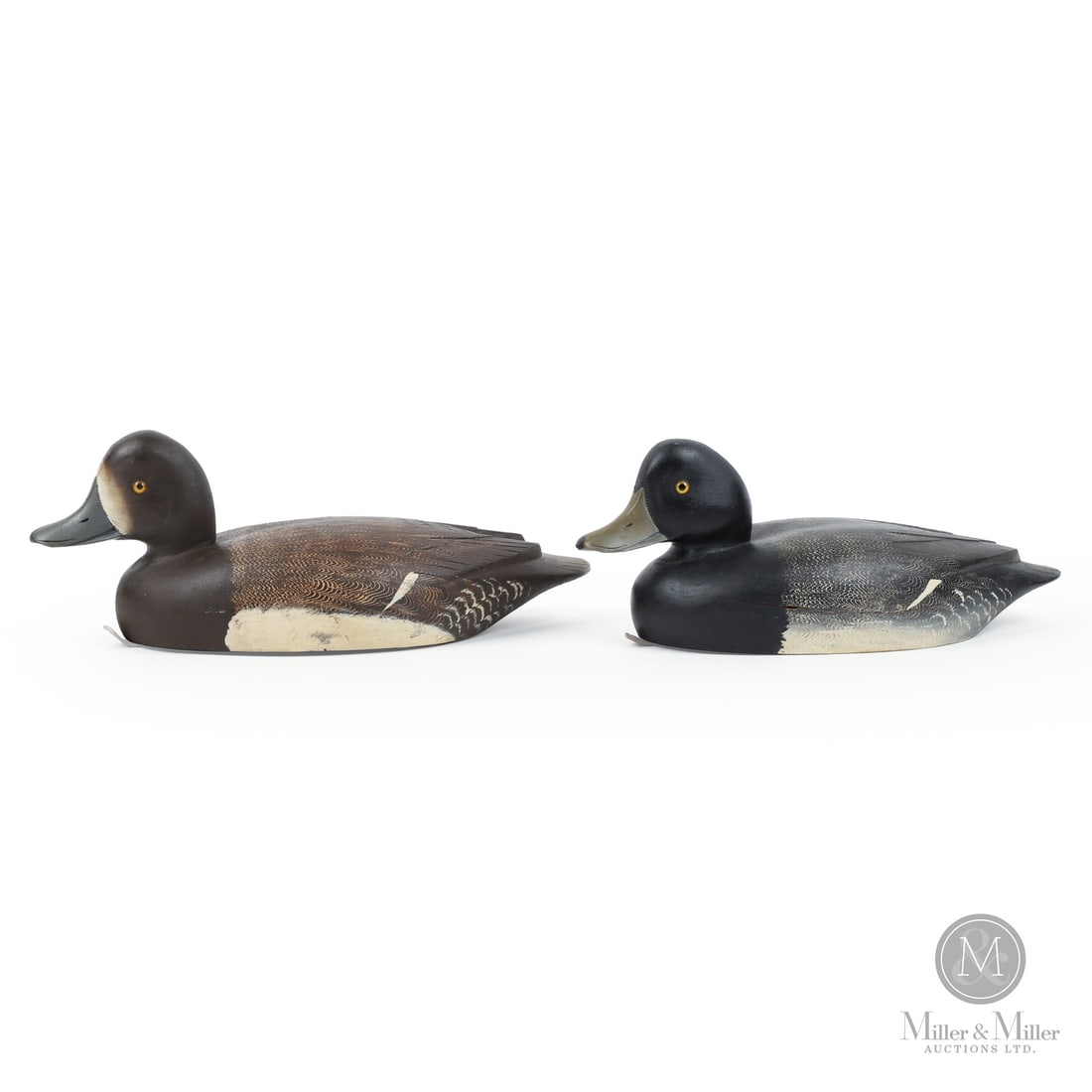 Pair of D. W. "Davey" Nichol Bluebill Decoys: 2 Smiths Falls, Ontario, Canada. Drake: 4.75" x 12.75" x 5.5". Hen: 5" x 14" x 6". Late 2nd Quarter 20th Century. Painted wood. Strong original paint with shelf wear only. Structurally excellent with 