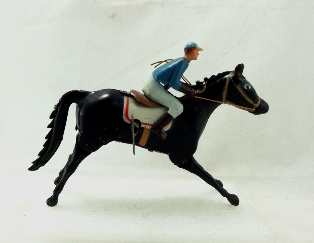 Wind up Toy. Horse & Jockey: Pressed Steel Windup Horse & Jockey #8. Rider has plastic face. ~Made in Spain~w Key~Works Overall very good w/ very slight paint chipping. 6" l. x 5" h.