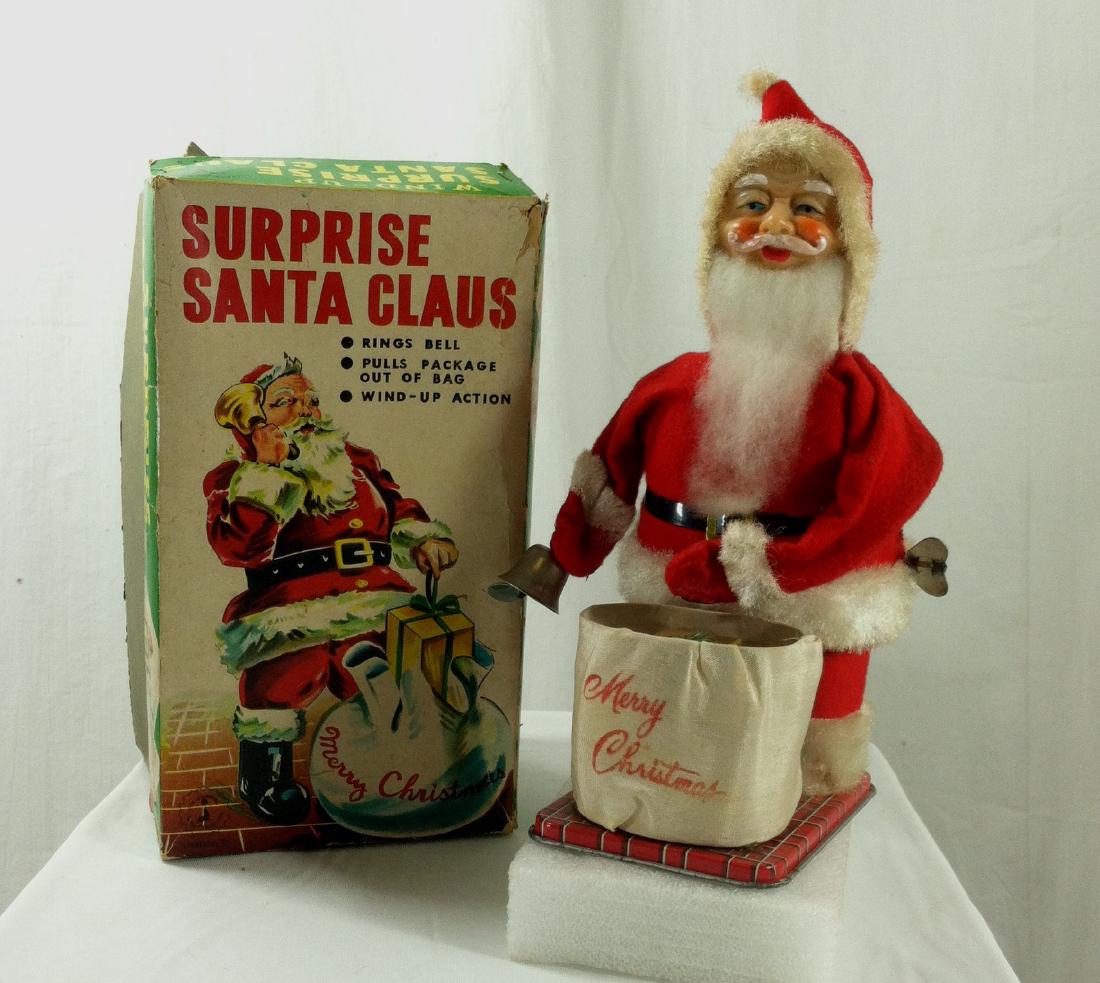 Surprise Santa Claus Wind Up in Original Box.: 8 1/2" tall wind up Santa Claus from Yonezawa Toys Co., Ltd. / Yonezawa Gangu.Has the original box and while the graphics on the cover are still good the box shows some wear and is missing a piece alo