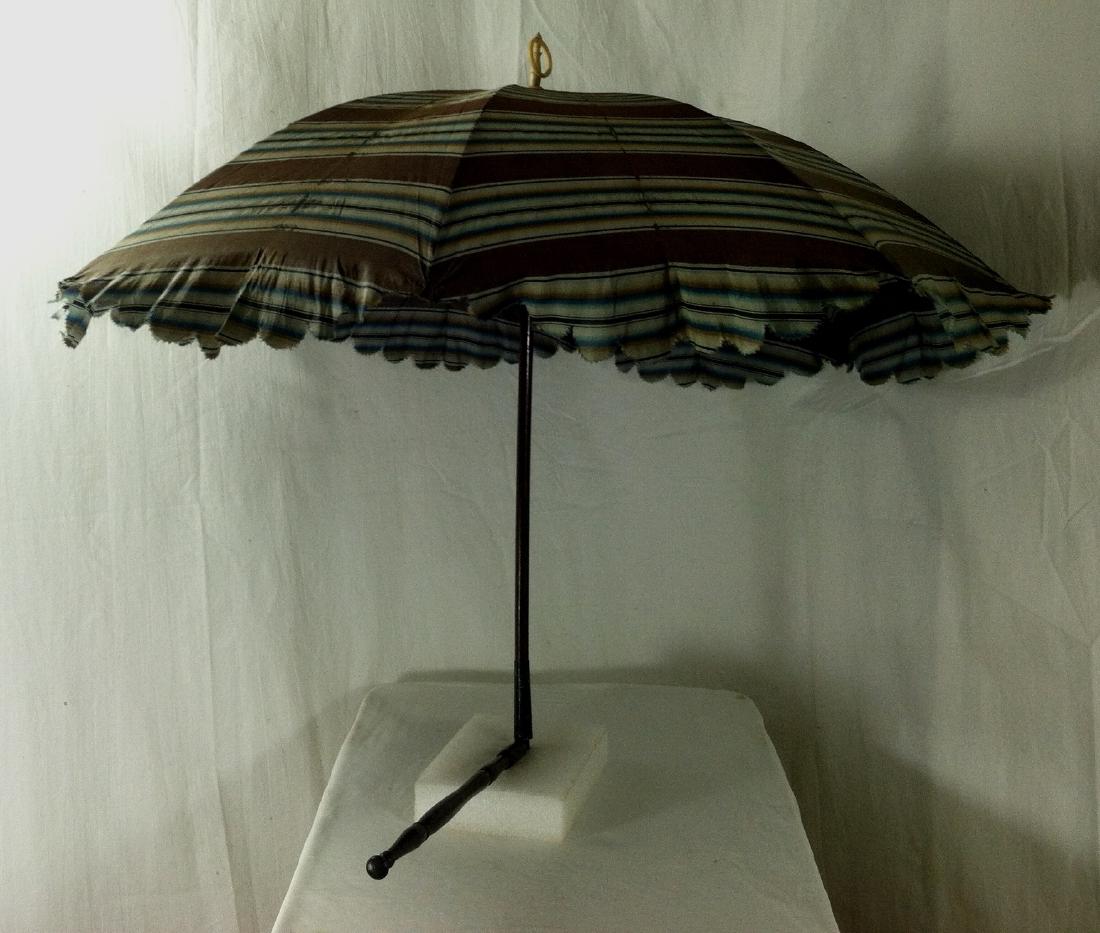 Antique Doll Carriage Parasol: When closed the antique doll-carriage parasol measures 19" long & when the handle is un-folded it is 30 1/2" long. The wood shaft is in fine & original fonosh with no issues. The metal arms open smoot