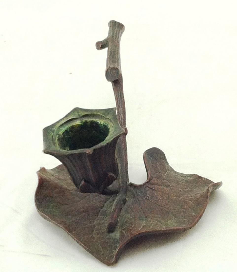 Bronze Arts & Crafts Chamberstick: Bronze Chamberstick is in a very naturalistic formed twig handle & leaf ending in a floral cup. Measures 7" l. x 4" across. No makers marks.