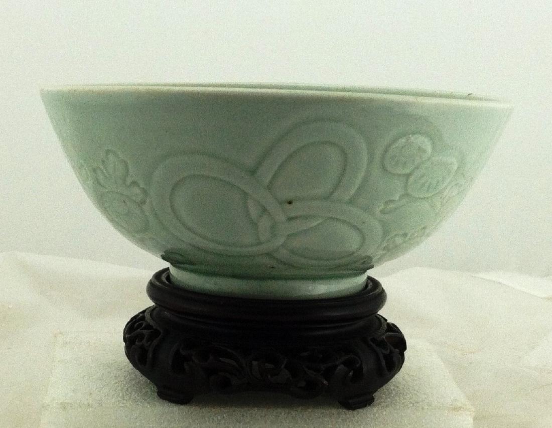 Pale Green Celadon Chinese Wedding Bowl: Bowl sits on a raised base which is 2 1/2" across. It is 2 3/4" h. and is 6" across the top. Molded flower & ring decoration on the sides. Not marked.