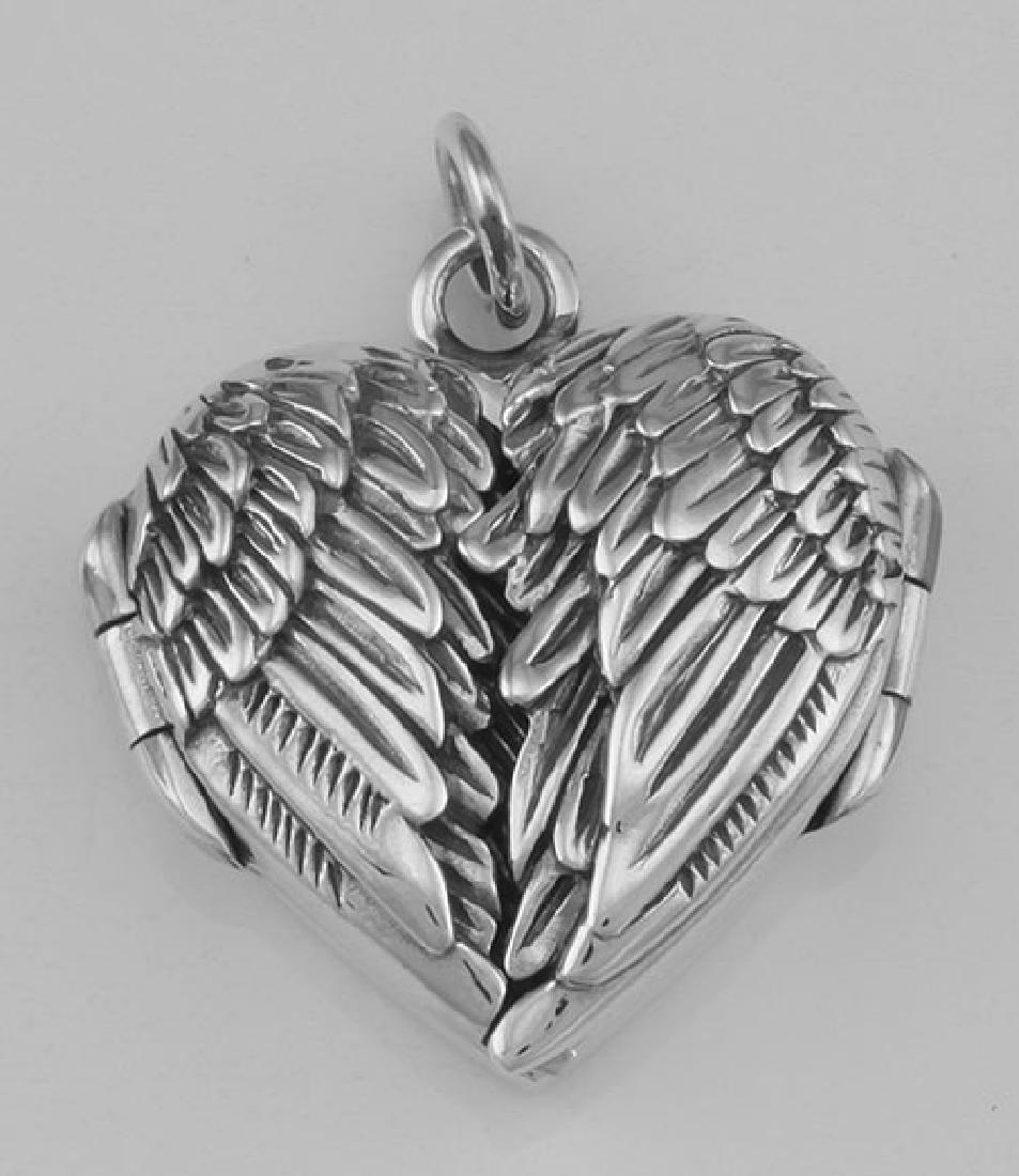 Beautiful Angel Wings Heart Locket In Fine Sterling Sil: Beautiful Angel Wings Heart Locket In Fine Sterling Silver **|**|** #HP-98 Sterling Silver Angel Wings Heart Locket - The front of this Heart shaped locket features two angel wings folded side by side