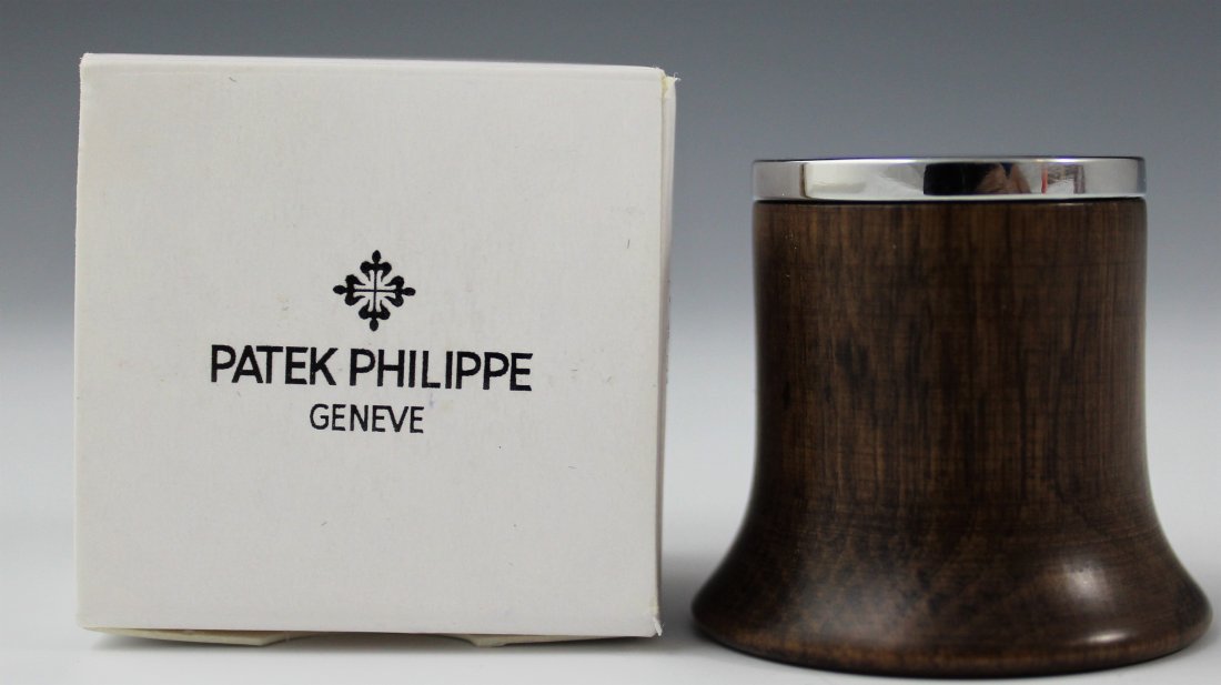 Patek Philippe Eye Glass: Patek Philippe issued eye glass Measures: 3 x 3 inches Comes with original wooden box