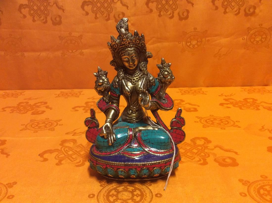 Tibetan White Tara Sculpture.: Tibetan White Tara Sculptiure made with bronze inlaid turquoise, coral and lapis.Hand crafted in Nepal. 6" tall, 4" wide and weighs 968 grams.
