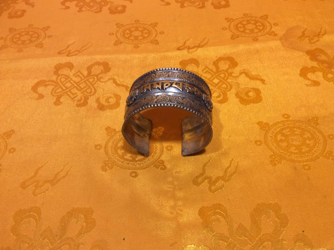 Tibetan Bracelet.: Tibetan Bracelet hand crafted in Nepal with copper, brass and silver filigreed and ornated "Om Mani Pedme Hung"- May All Living Beings Be Free From Sufferings. Measures 18" long, 2" wide and weighs 68