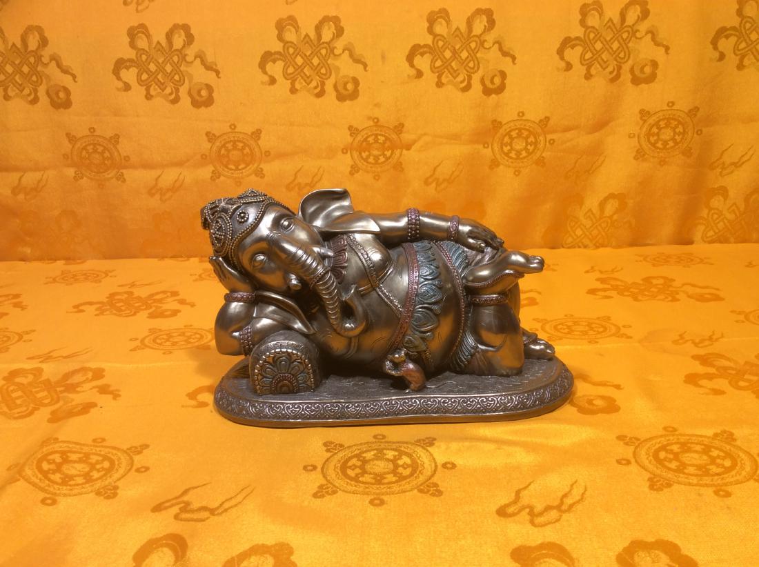 Reclining Ganesh: Reclining Ganesh Sculpture made with oxide copper. Ganesh is believed as God of Wealth and Obstacle Remover. 8" tall, 5" wide and weighs 728 grams.