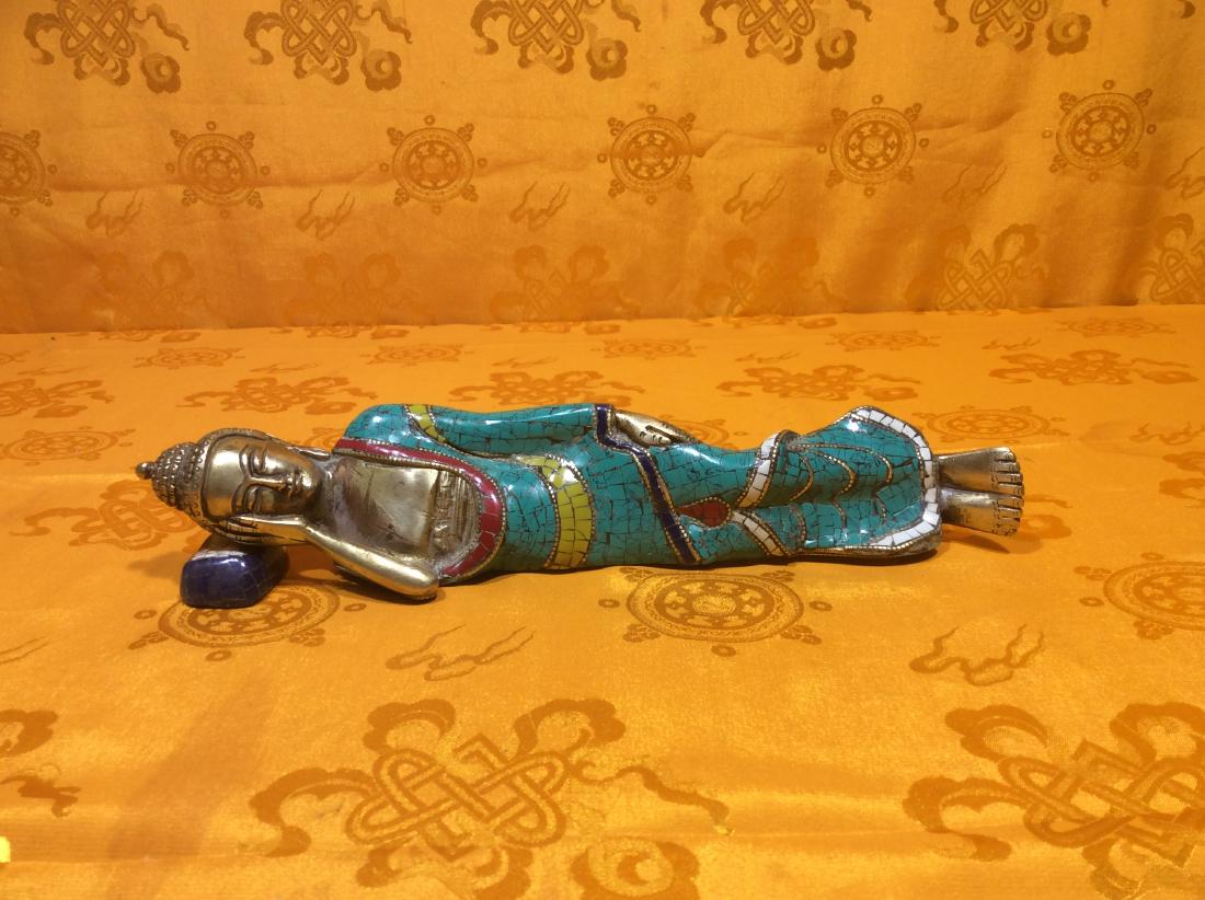 Recling Buddha Sculpture.: Reclining Buddha Sculpture made with solid bronze inlaid turquoise, coral and lapis. Hand crafted in Nepal in recent years. Measures 10" tall, 2" wide and weighs 1,065 grams.