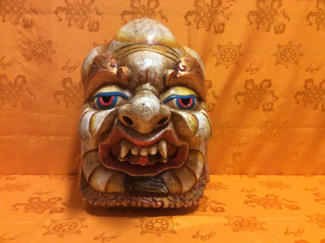 Tibetan Wooden Mask.: Tibetan Wooden Mask, hand crafted and hand painted in Nepal by a Tibetan Artist in 1960s. There is a small crack on the top backside. Measures 12"x10"x10" and weighs 1,320 grams.