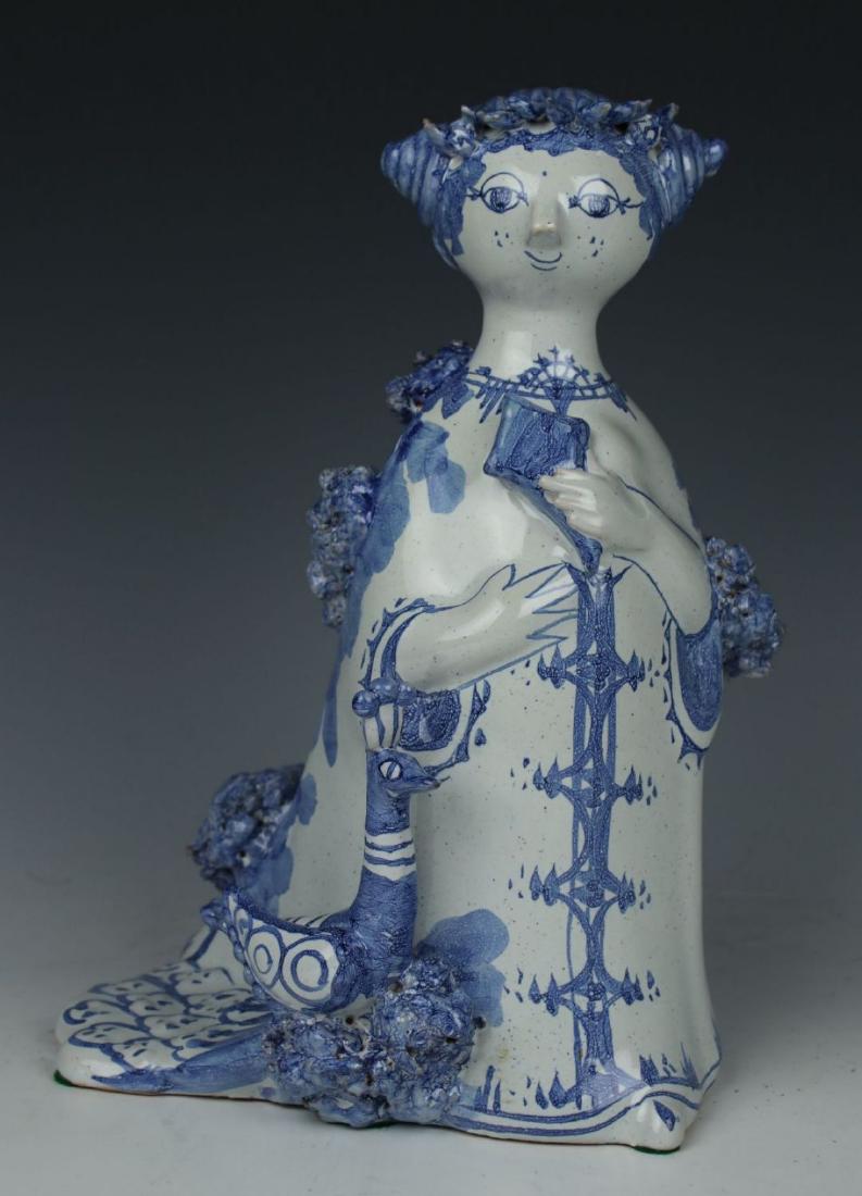 Bjorn Wiinblad figurine "Aunt Ella with Peacock": MANUFACTURE: Nymolle (DENMARK) DESIGNED: Bjorn Wiinblad (1918-2006) NAME: Aunt Ella with Peacock SERIES: Aunt Ella YEAR: 1973 NUMBER: M16 CONDITION: Peacock's crest was reattached. NO BOX HEIGHT: 8 1/