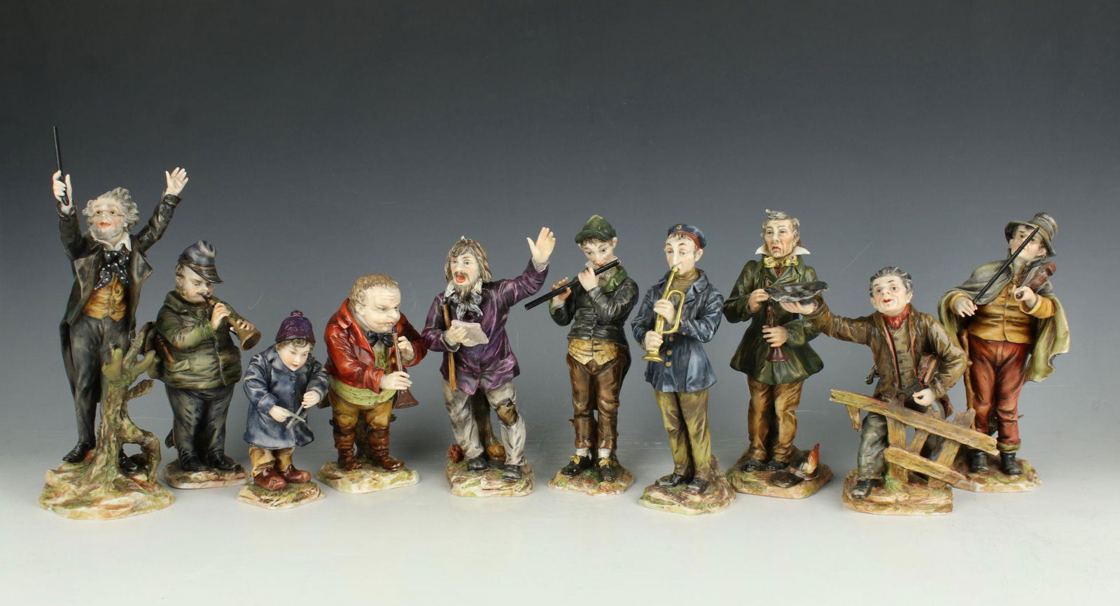 Eckert Dresden Volkstedt 10 figurines "Musicians": MANUFACTURE: Richard Eckert Dresden Volkstedt (GERMANY) NAME: Wandering Musicians YEAR: 1909 - 1918 CONDITION: Minor restorations to fingers and musical instruments. HEIGHT: 8 1/2 inch / 21 cm (talles