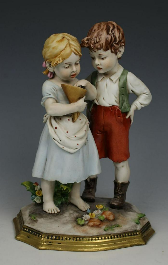 Capodimonte Benacchio Figurine "Boy and Girl Eating: MANUFACTURE: Triade (Italy) SCULPTOR: Benacchio NAME: Boy and Girl Eating Candies NUMBER: 747 YEAR: 1970-s CONDITION: Excellent. Minor damages of flowers if any. NO BOX. HEIGHT: 7 1/2 inch / 19 cm WID
