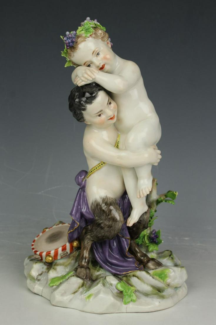 Meissen Acier Figurine D28 "Faun Hugging Nymph": MANUFACTURE: Meissen (GERMANY) SCULPTOR: Michel Victor Acier in circa 1771 NAME: Faun Hugging Nymph NUMBER: D28 YEAR: 1850-1925 CONDITION: Missing two tambourine bells. Some damages of leaves. HEIGHT: