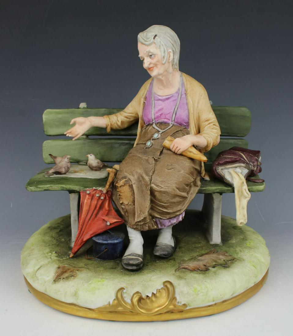 Capodimonte Bruno Merli Figurine "Old Woman Feeding Birds": MANUFACTURE: King's Porcelain (Italy) SCULPTOR: Bruno Merli NAME: Old Woman Feeding Birds YEAR: 1952 - 1960 NUMBER: 293 CONDITION: One side of bench was restored. NO BOX. HEIGHT: 8 1/2 inch / 21 cm WI