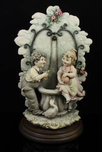 Capodimonte Bruno Merli Figurine "Children at Well": MANUFACTURE: Florence (Italy) SCULPTOR: Bruno Merli NAME: Children at the Well YEAR: 1983 CONDITION: Excellent, no chips, no cracks. NO BOX. HEIGHT: 10 inch / 25 cm WIDTH: 5 1/2 inch / 14 cm DEEP: 5 1