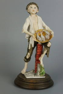 Giuseppe Armani Figurine "Boy Selling Fish": MANUFACTURE: Florence - Giuseppe Armani (Italy) NAME: Boy Selling Fish NUMBER: - ISSUED: circa 1975 CONDITION: Excellent. No chips, no cracks. NO BOX. HEIGHT: 8 inch / 20 cm WIDTH: 4 inch / 10 cm DEEP